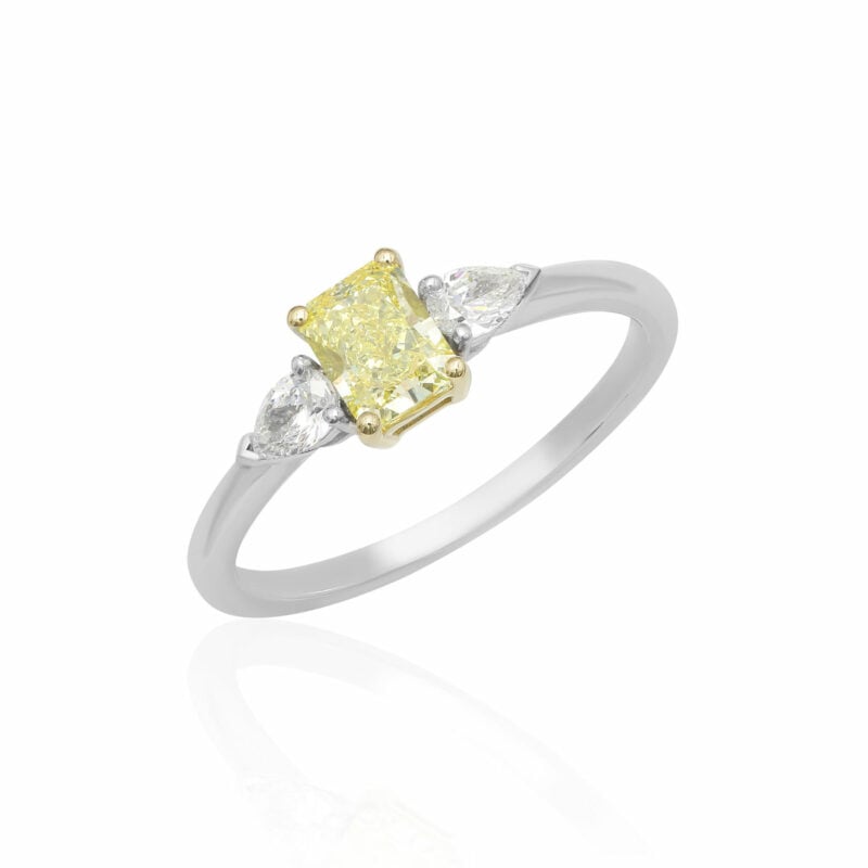Three-stone rectangular brilliant cut and pear cut diamonds engagement ring 