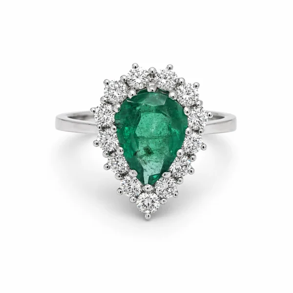 Pear cut emerald ring in 18K white gold with a 1.67 ct green emerald surrounded by a halo of 0.77 ct natural round brilliant cut diamonds.