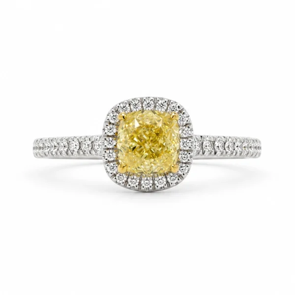 Fancy intense yellow diamond halo ring with 1.01 ct SI2 GIA-certified cushion diamond and 0.19 ct D–F VS diamonds in 18k white gold.