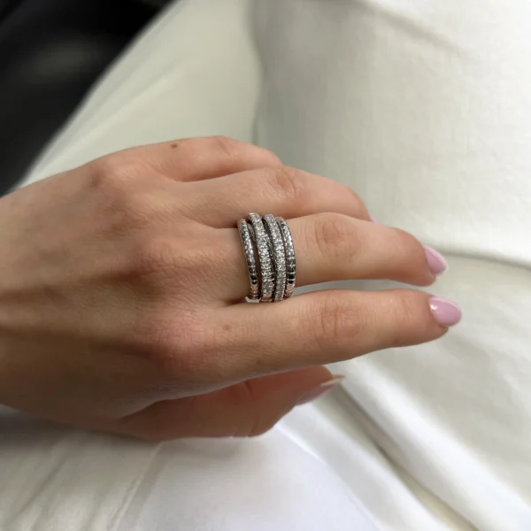 Sculptural elegance unfolds in this Diamond Spring Ring crafted in 18K white gold, designed with fluid layered lines and set with 0.55 carats of natural diamonds in exceptional DE colour and IF/VVS clarity. A refined statement piece balancing modern design with luminous brilliance.