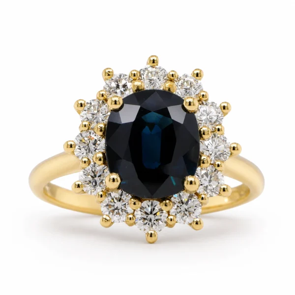 Yellow gold sapphire diamond ring in 18k with a 2.14 ct oval blue sapphire and 0.75 ct natural diamonds, front view.