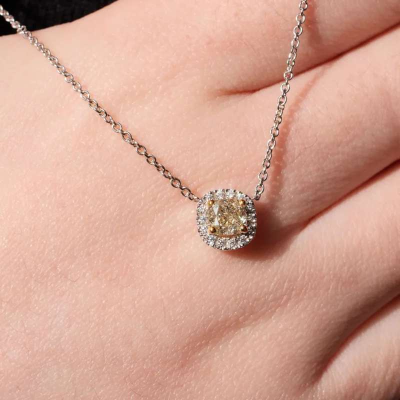 Yellow Cushion Cut Diamond Pendant Shown On Hand With Natural Light Reflection