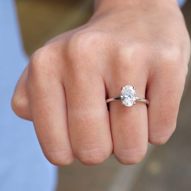 Full Hand View Wearing A 1.51 Carat Oval Cut Diamond Solitaire Ring In 18K White Gold, Showcasing Its Elegant Proportions.