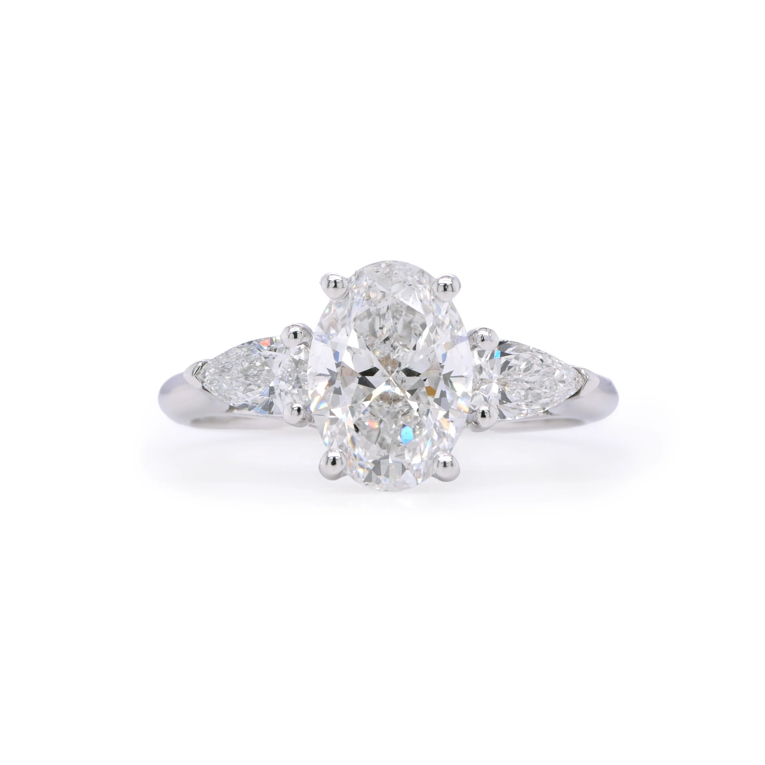 1.50 Ct Oval E Si2 Gia Diamond Ring With 0.34 Ct Pear Sides In 18K White Gold 1 - Orogem Jewelers Front View Of 18K White Gold Ring With 1.50 Ct E Si2 Gia-Certified Oval Diamond And 0.34 Ct E Vs Pear-Cut Side Stones.