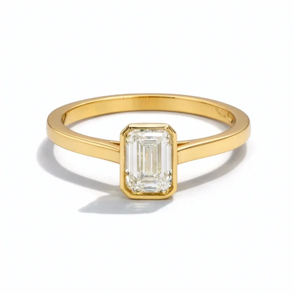 Emerald-cut 0.72 ct G VS2 diamond bezel ring in 18k yellow gold
