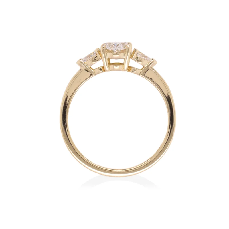 Side View Of Three-Stone Oval Diamond Ring In 18K Yellow Gold With Pear Sidestones.
