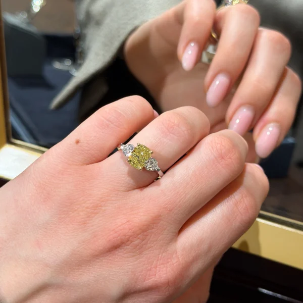 2.01 ct Fancy Yellow cushion cut ring with heart sidestones in 18K gold