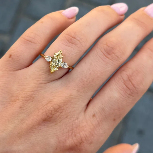 Marquise yellow diamond ring with pear side diamonds in 18k gold