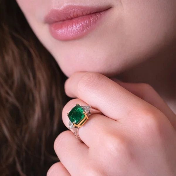 Emerald and diamond ring in two-tone 18k gold worn portrait view