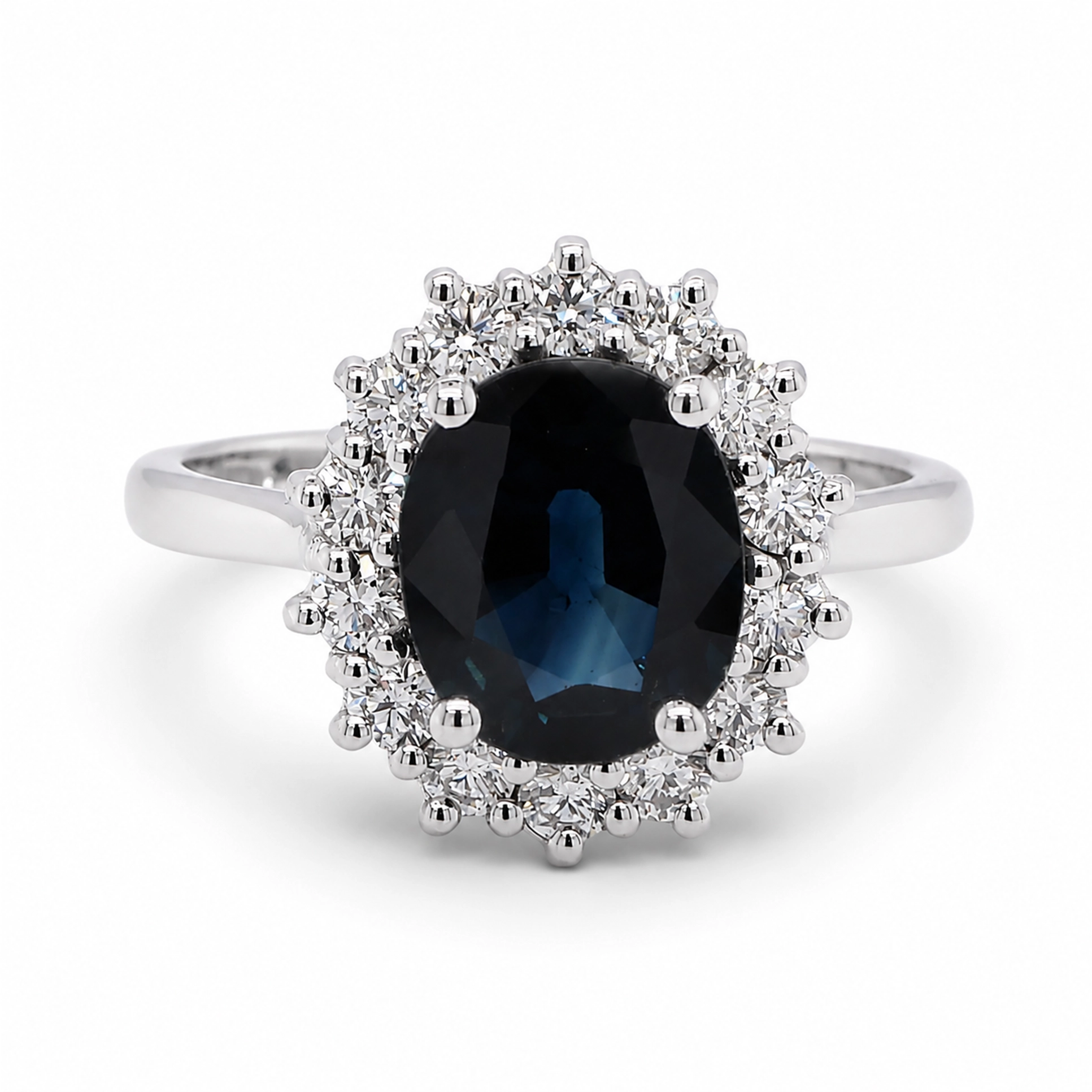 Blue Sapphire Diamond Ring In 18K White Gold With Oval Halo 4 - Orogem Jewelers Front View Of A Blue Sapphire Diamond Ring In 18K White Gold With A 2.19 Ct Oval Sapphire And 0.51 Ct D-F Vs Natural Diamonds.