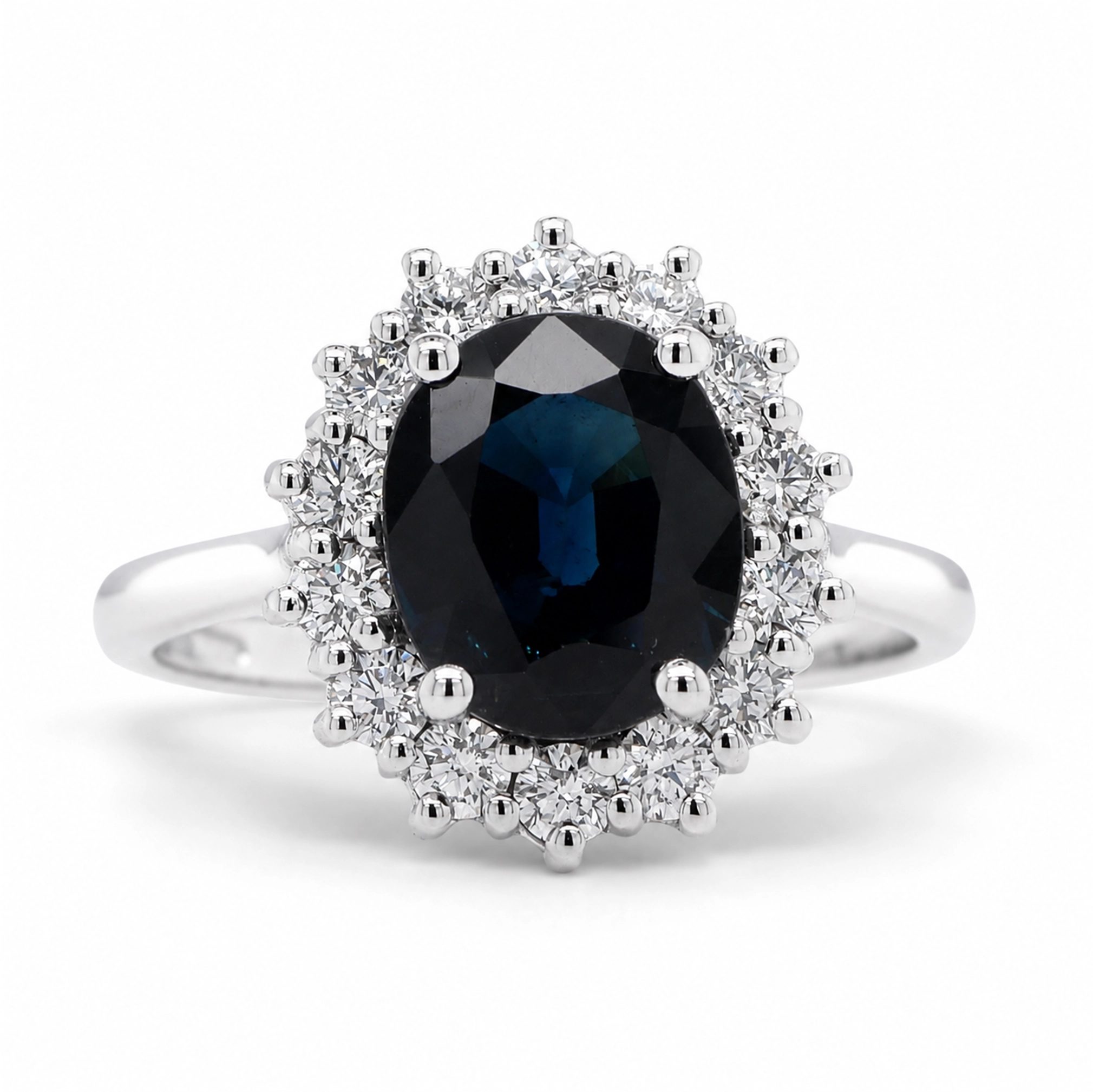 Blue Sapphire Diamond Ring In 18K White Gold With Oval Halo 1 - Orogem Jewelers Front Angled View Of A Blue Sapphire Diamond Ring In 18K White Gold With Oval Sapphire Center And Diamond Halo.
