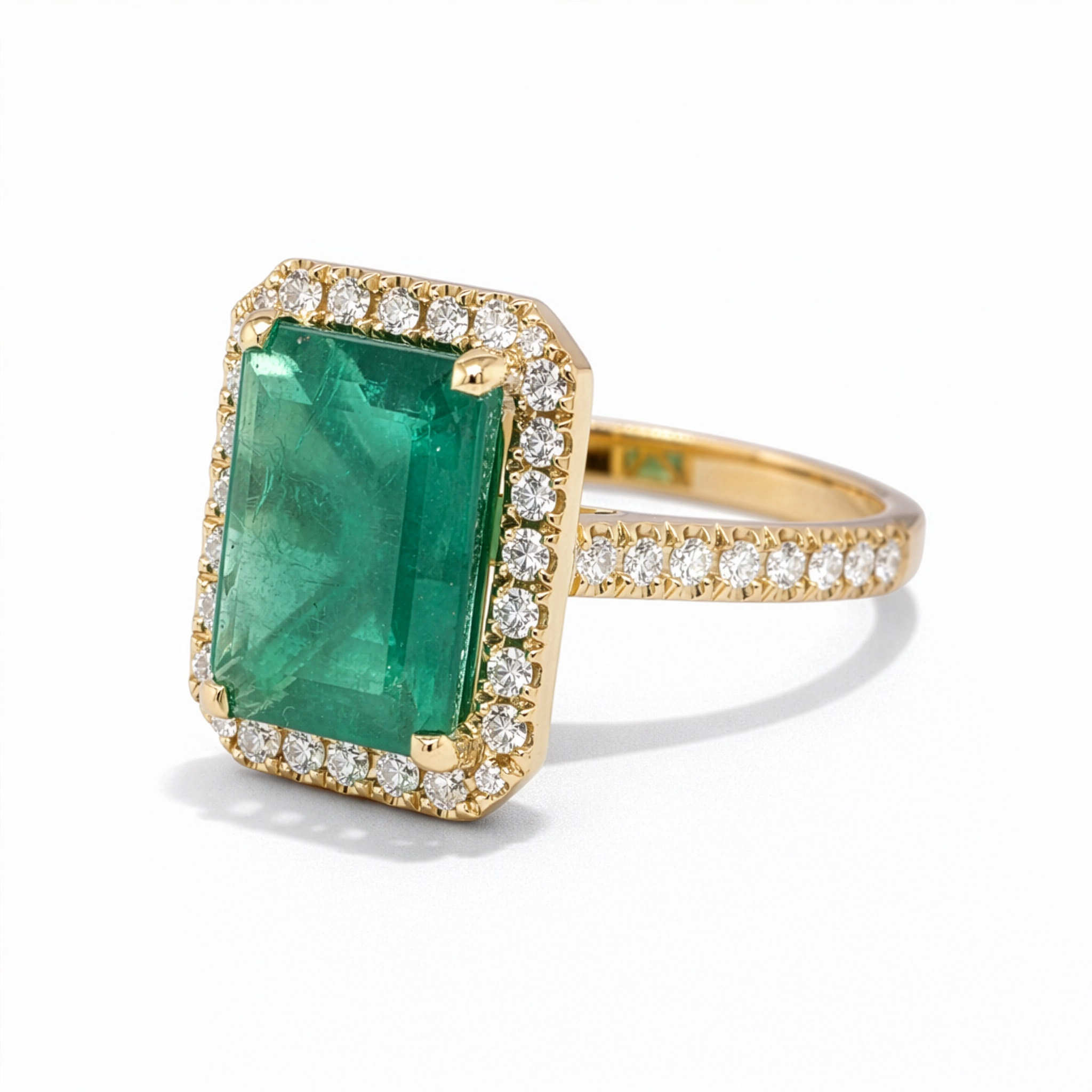 Emerald Cut Emerald Ring With Diamond Halo In 18K Yellow Gold 3 - Orogem Jewelers Side View Of Emerald Cut Emerald Ring With Diamond Halo And Pavé Band