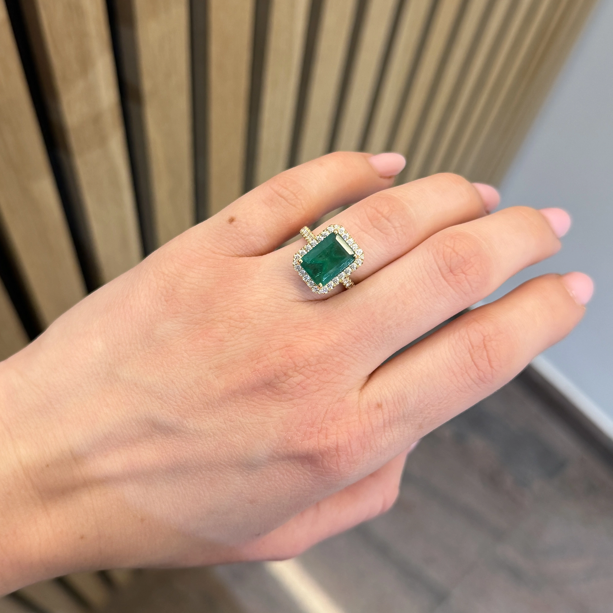 Emerald Cut Emerald Ring With Diamond Halo In 18K Yellow Gold 4 - Orogem Jewelers Emerald Cut Emerald Ring Worn On Hand With Pavé Diamond Band