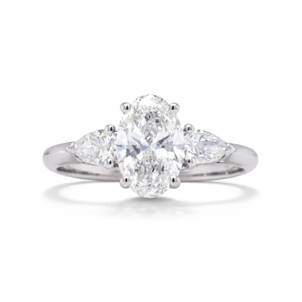 Front view of oval lab grown diamond ring in 18k white gold with 1.00 ct oval cut lab grown diamond and pear-shaped side stones.