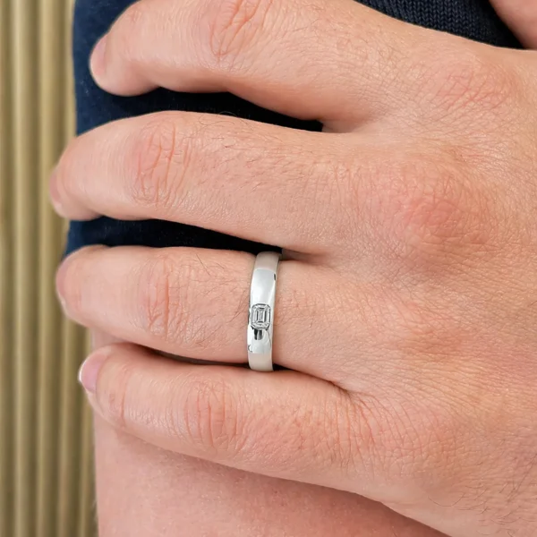 Emerald cut flush set diamond ring in 18K white gold with GIA-certified F color IF clarity diamond, sleek minimalist band