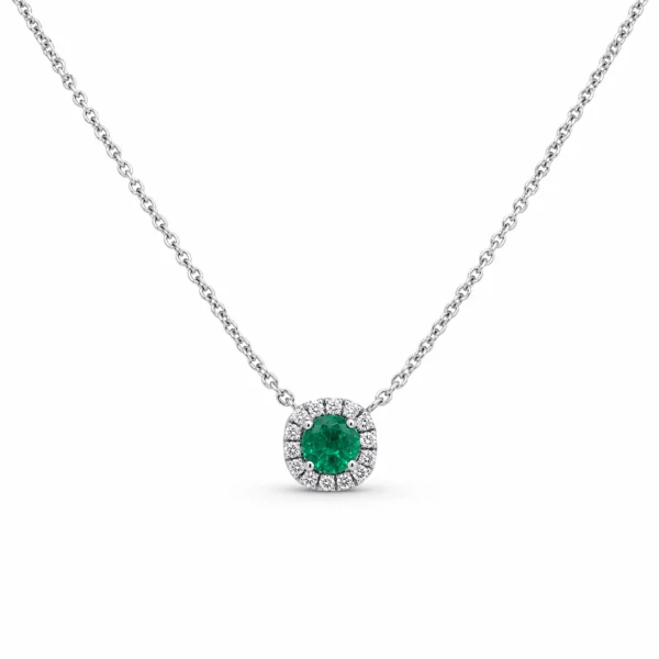 Emerald halo pendant necklace in 18k white gold with a 0.27 ct round-cut emerald and 0.09 ct D–F VS natural diamonds.