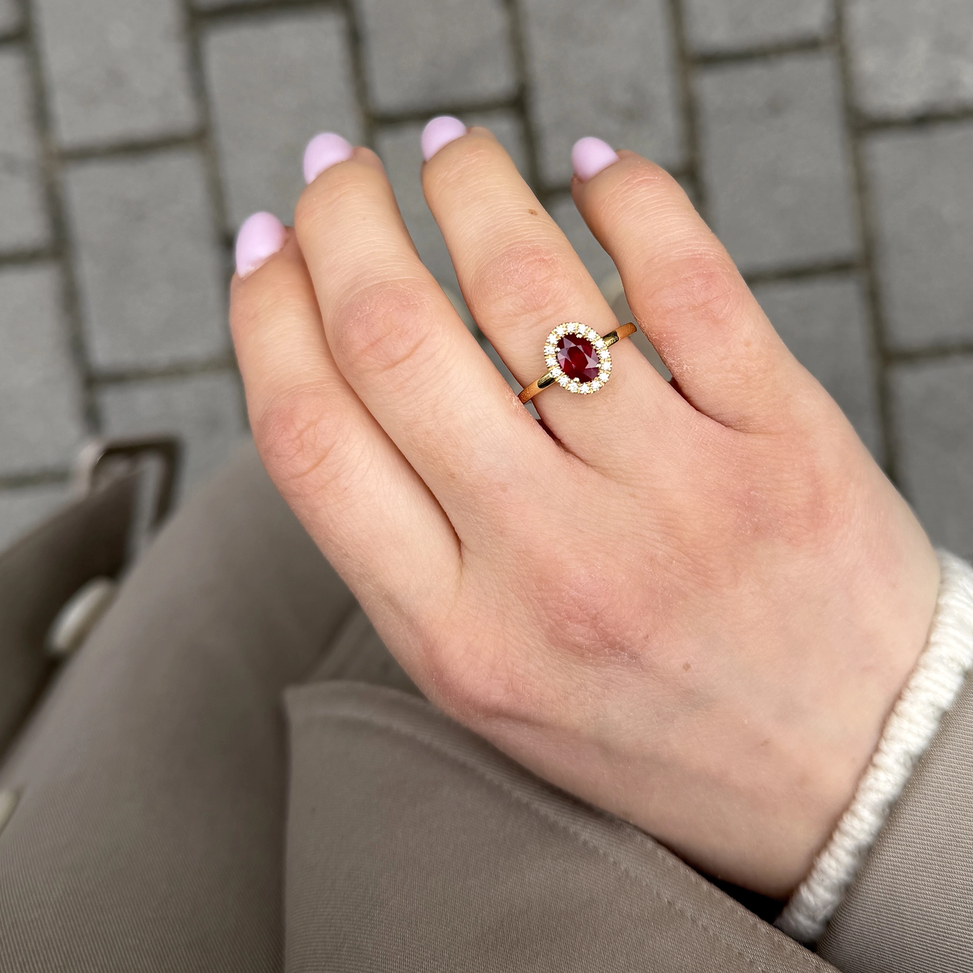 Natural Ruby Halo Ring In 18K Yellow Gold With Oval Ruby Diamonds 2 - Orogem Jewelers Oval Natural Ruby Halo Ring Worn On The Hand In 18K Yellow Gold With A Delicate Surround Of Natural Diamonds.