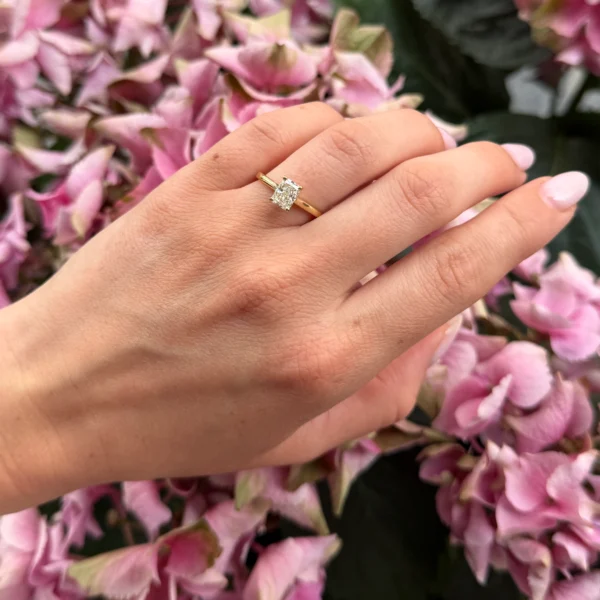 Radiant solitaire diamanten ring gedragen aan de hand in 18k geelgoud met een rechthoekige middendiamant van 1,01 ct.