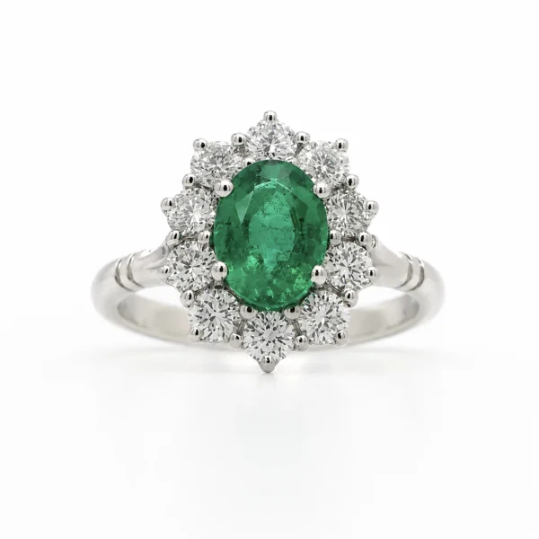 Oval emerald halo ring in 18k white gold with a 1.32 ct oval emerald and 0.87 ct D-F VS diamonds, front view.