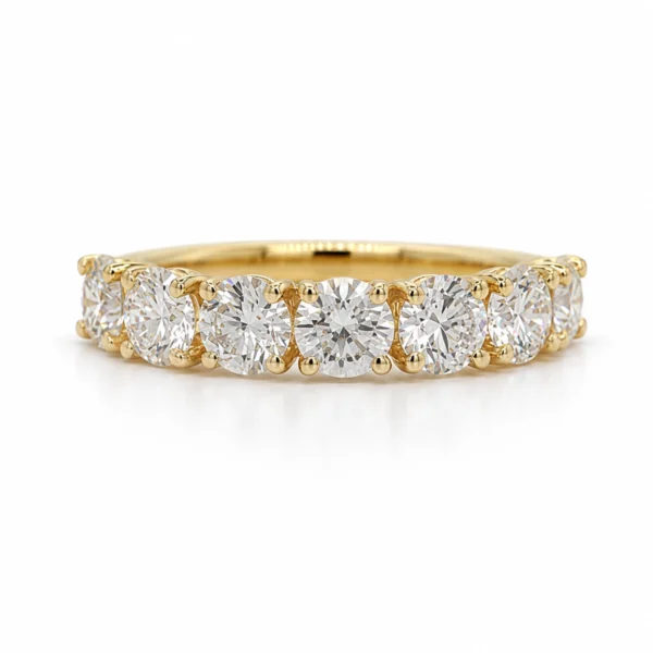 Seven stone diamond band in yellow gold with seven 0.30 ct F VS1 GIA-certified round diamonds totaling 2.10 ct, front view.