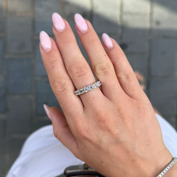 2.82 ct Asscher-cut diamond band worn on the hand with nine GIA-certified E VVS diamonds in 18k white gold.