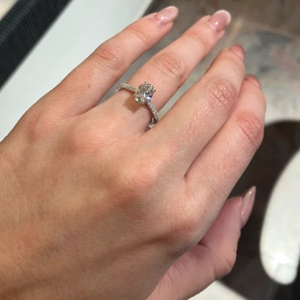 The 1.00 ct oval diamond ring worn, showing the length-to-width ratio of the stone against the finger in daylight.